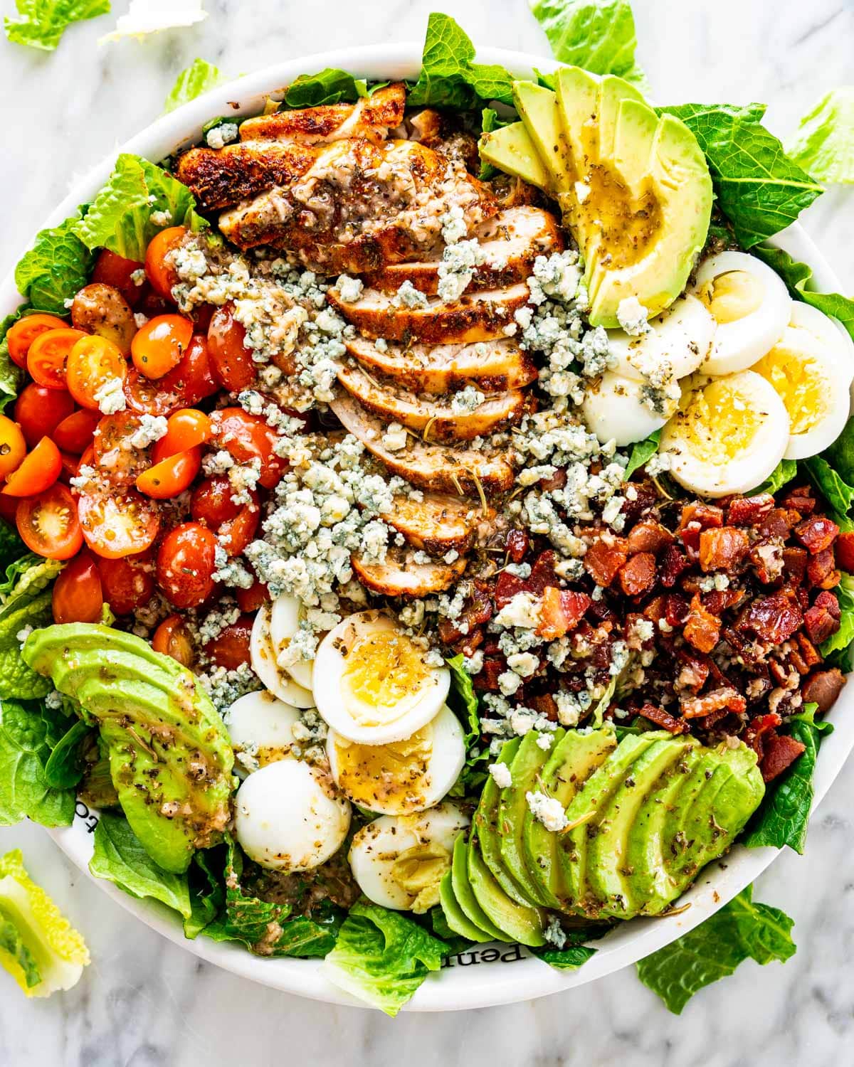 overhead shot of cobb salad on a white bowl