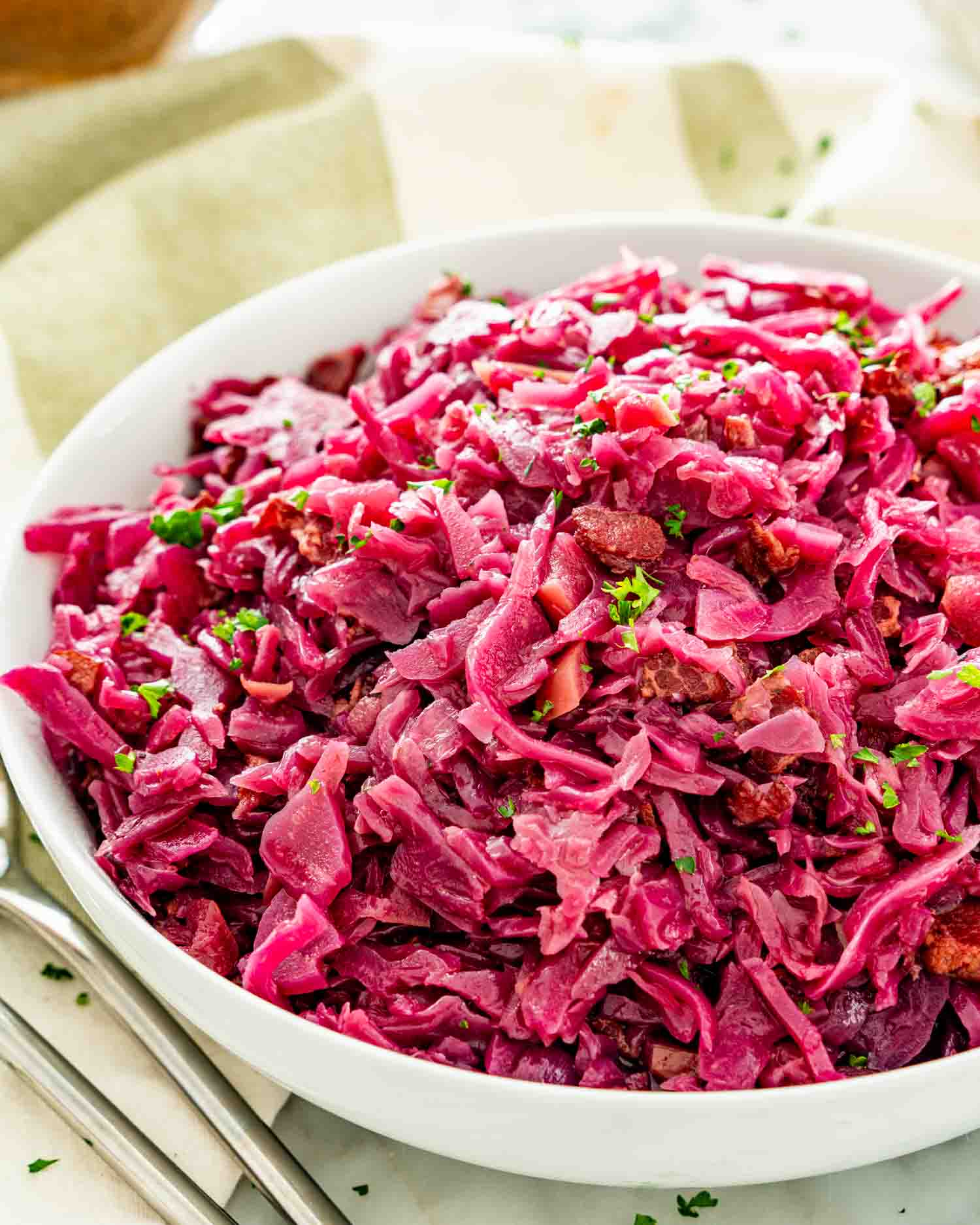 a big white bowl filled with freshly made german red cabbage.
