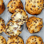 freshly baked chocolate chip muffins in a muffin pan.