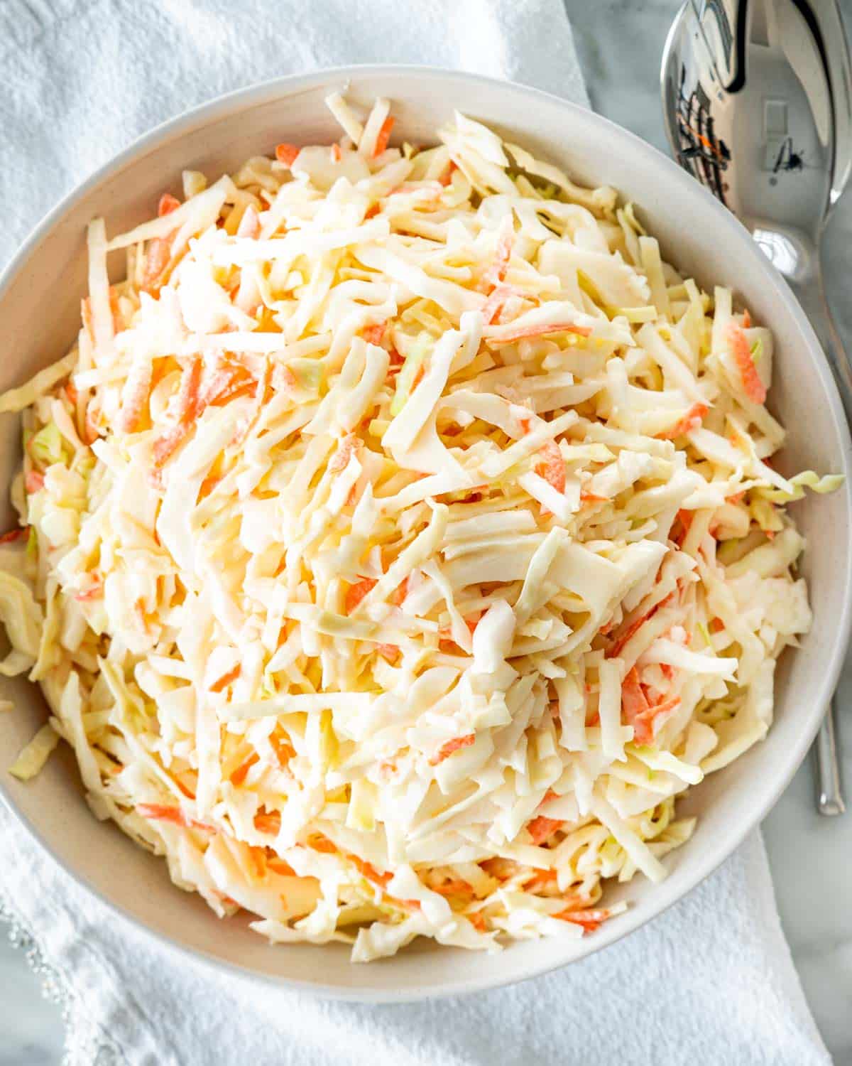 overhead shot of coleslaw in a white bowl