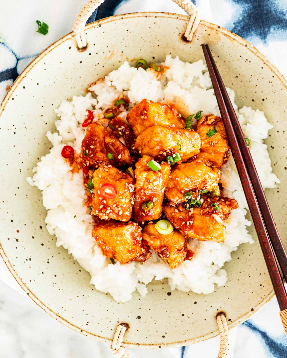 korean fried chicken over a bed of sticky white rice
