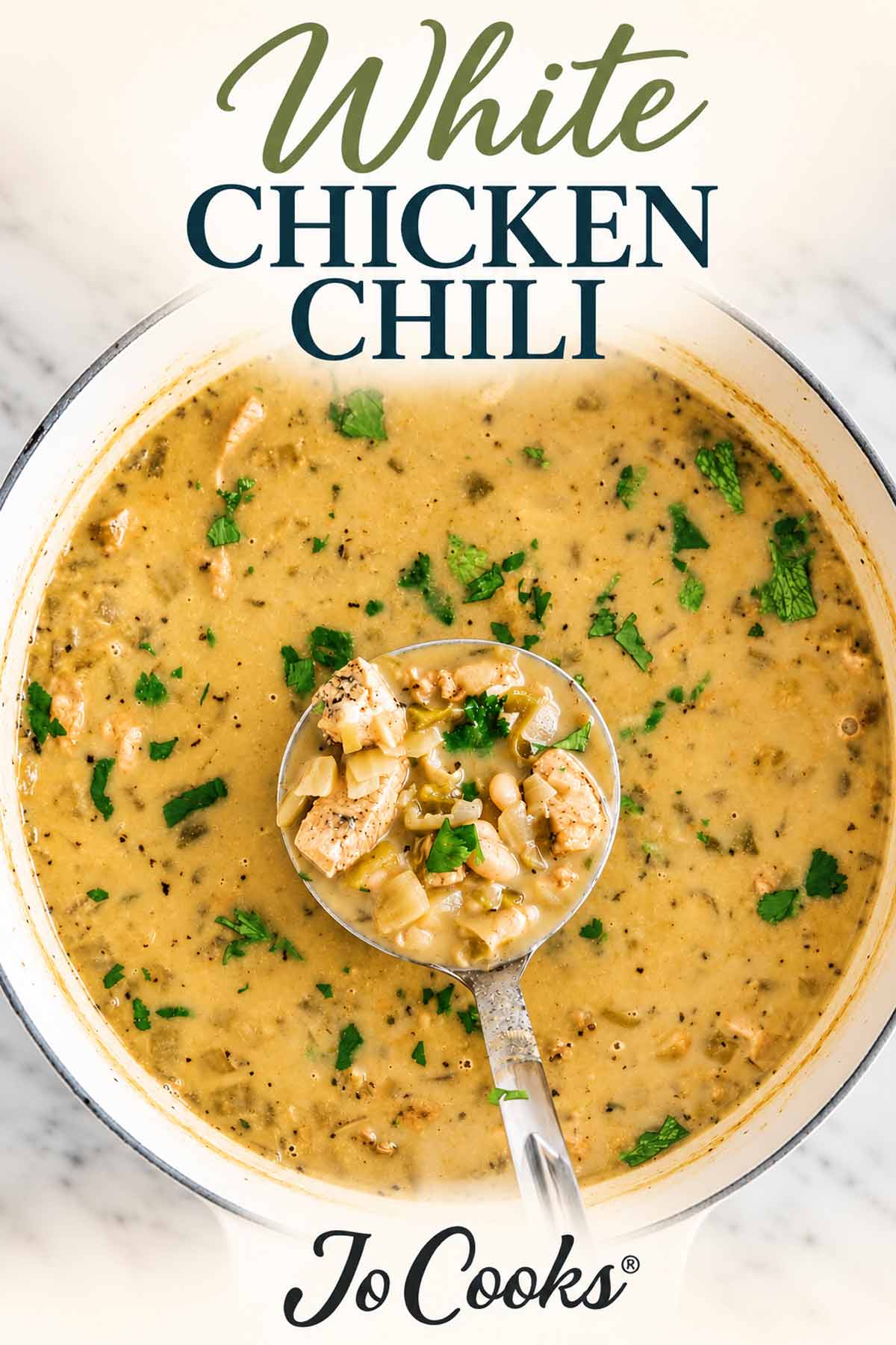 Overhead pot of white chicken chili with a filled ladle, recipe title above, and Jo Cooks logo below.
