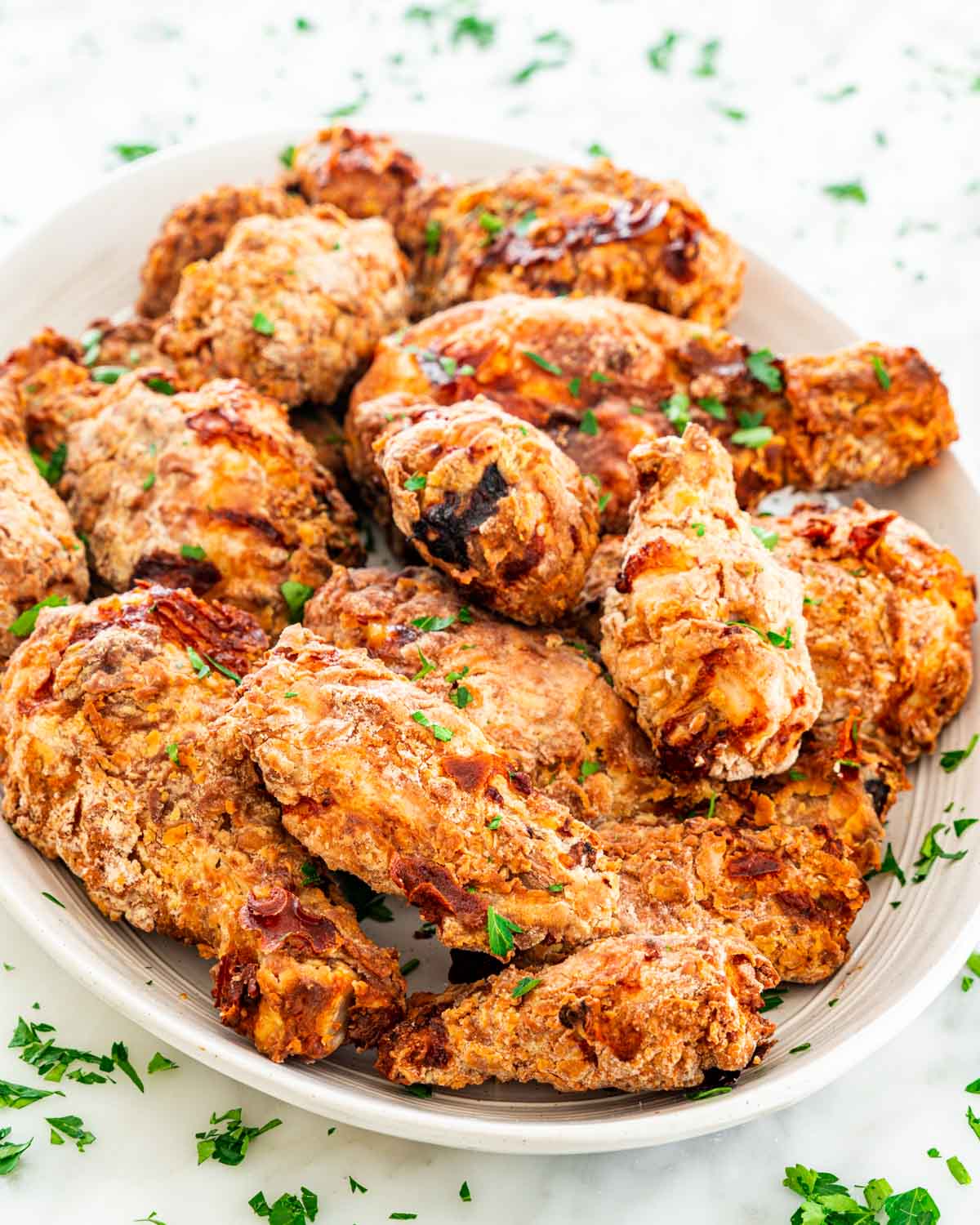 fried chicken on a serving platter garnished with parsley