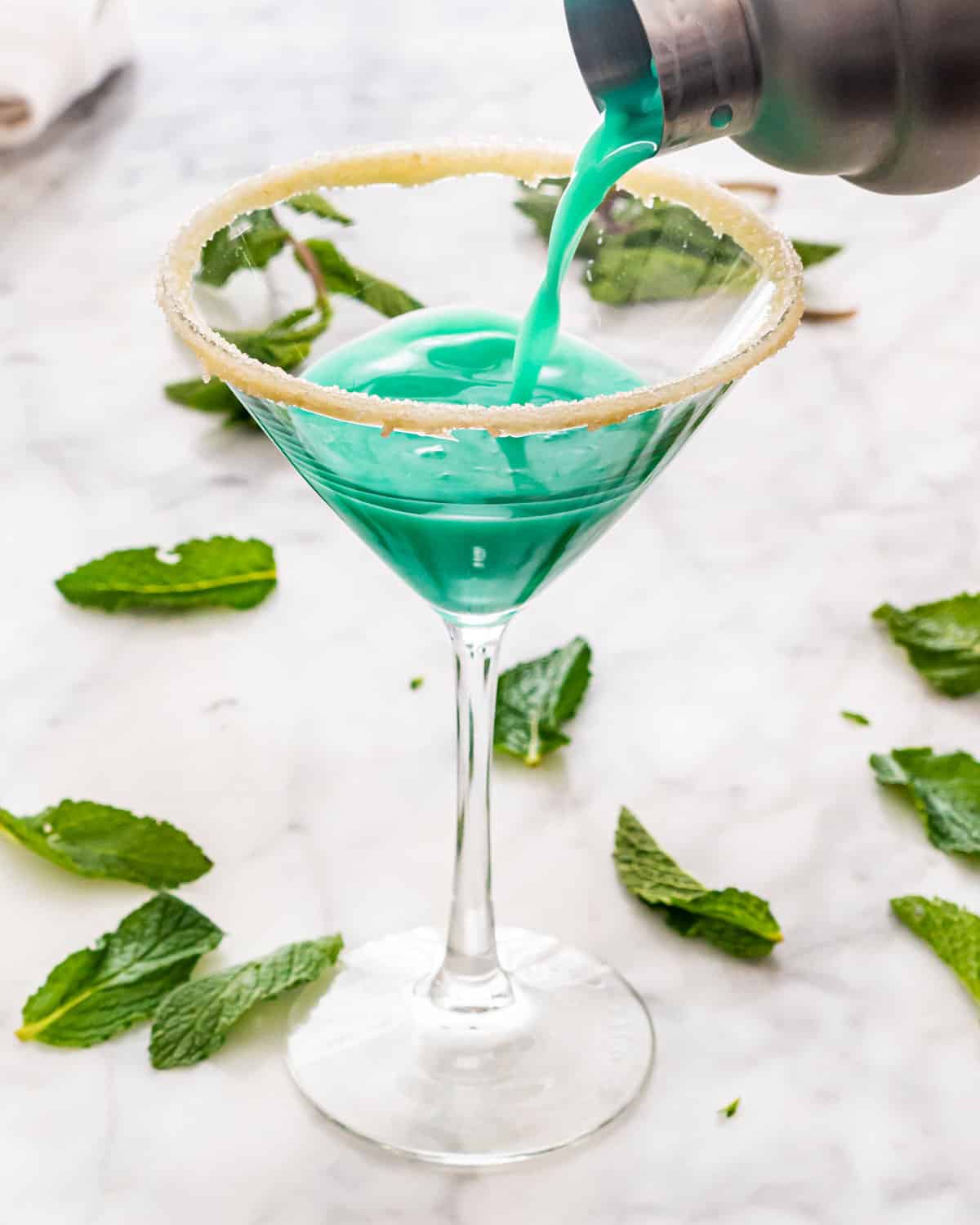 pouring grasshopper in a  martini glass