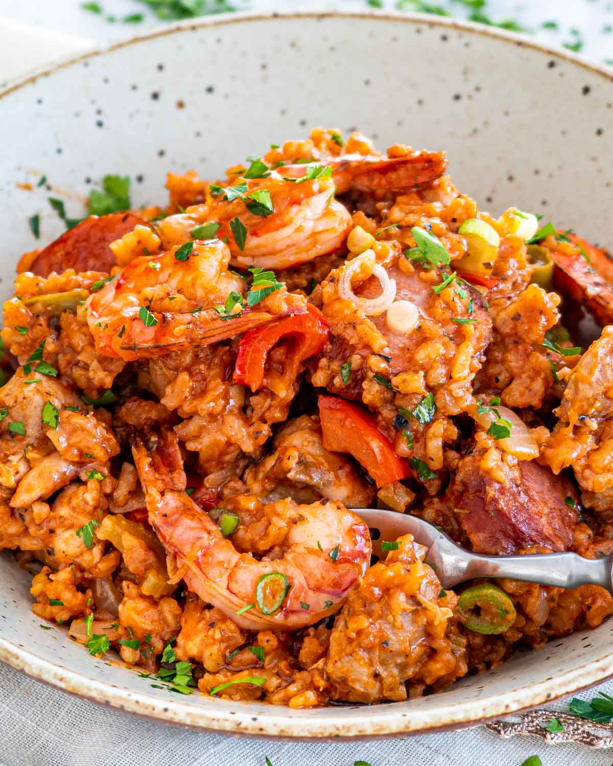 jambalaya in a plat with a fork in it