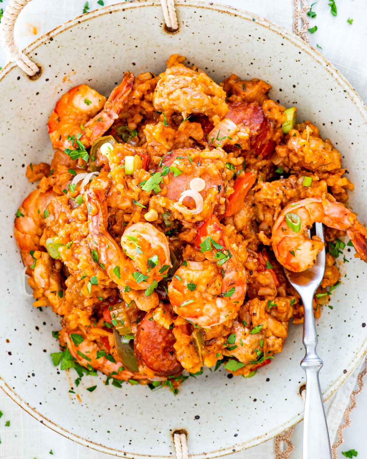 overhead shot of jambalaya in a plate with a fork in it