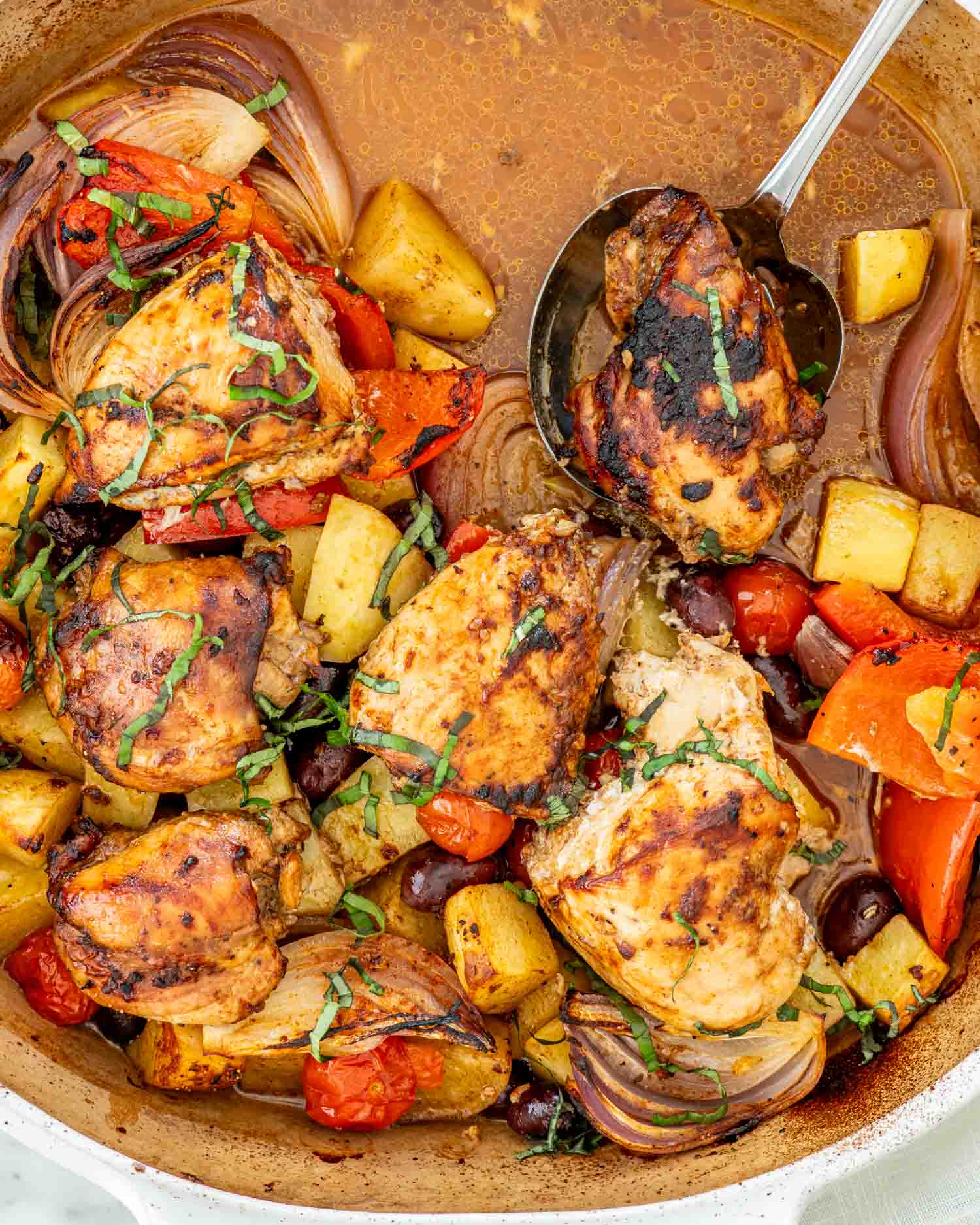 fresh out of the oven, roasted chicken and vegetables in a baking dish.