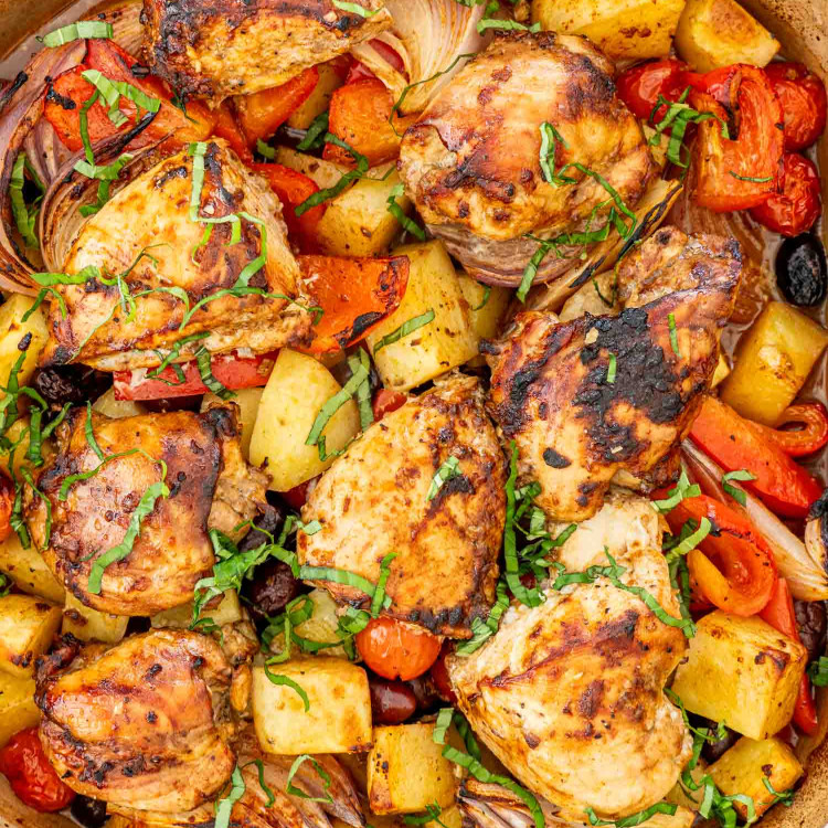fresh out of the oven, roasted chicken and vegetables in a baking dish.