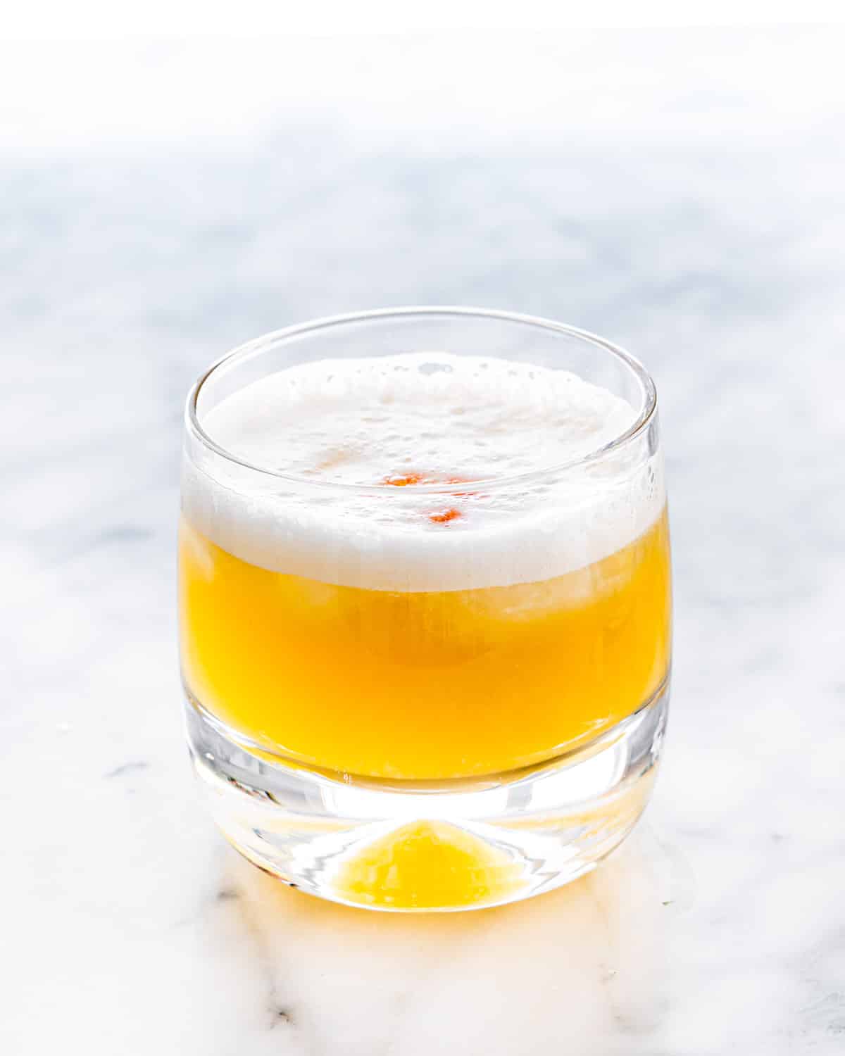 a whiskey sour in a rocks glass