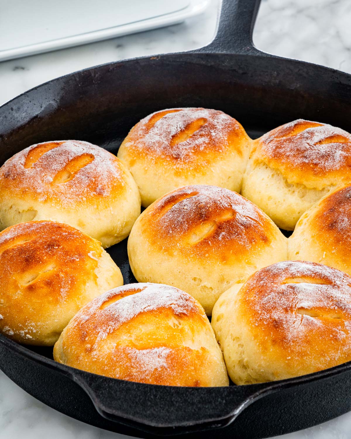 dinner rolls in a cast iron skillet made with 2 ingredient dough
