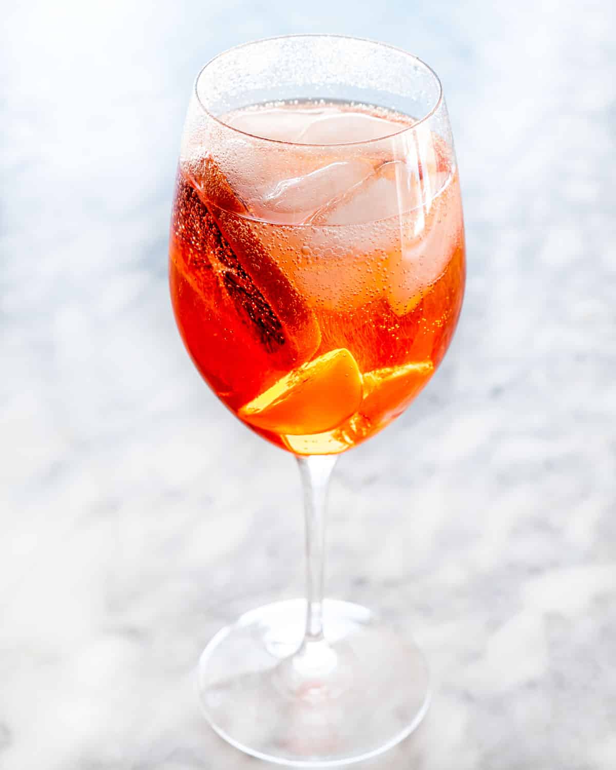 a wine glass with aperol spritz