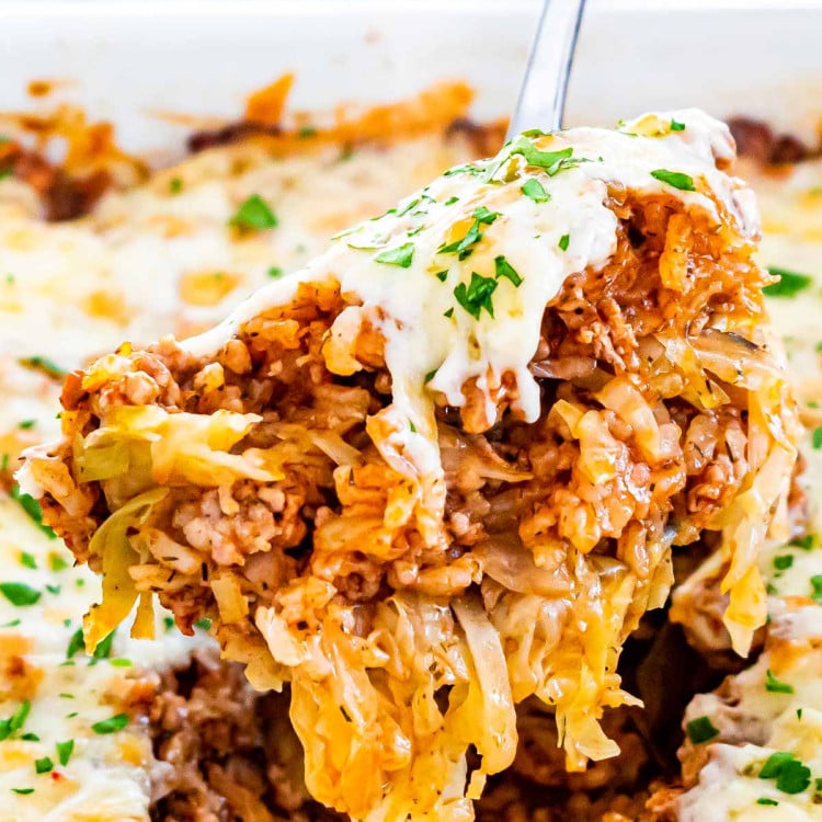 close up shot of a serving spoon taking a portion of cabbage roll casserole
