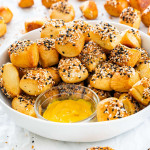 a bowl of pretzel bites with a side of mustard to dip