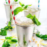 side shot of 3 mint julep cups filled with mint julep, crushed ice and lots of fresh mint