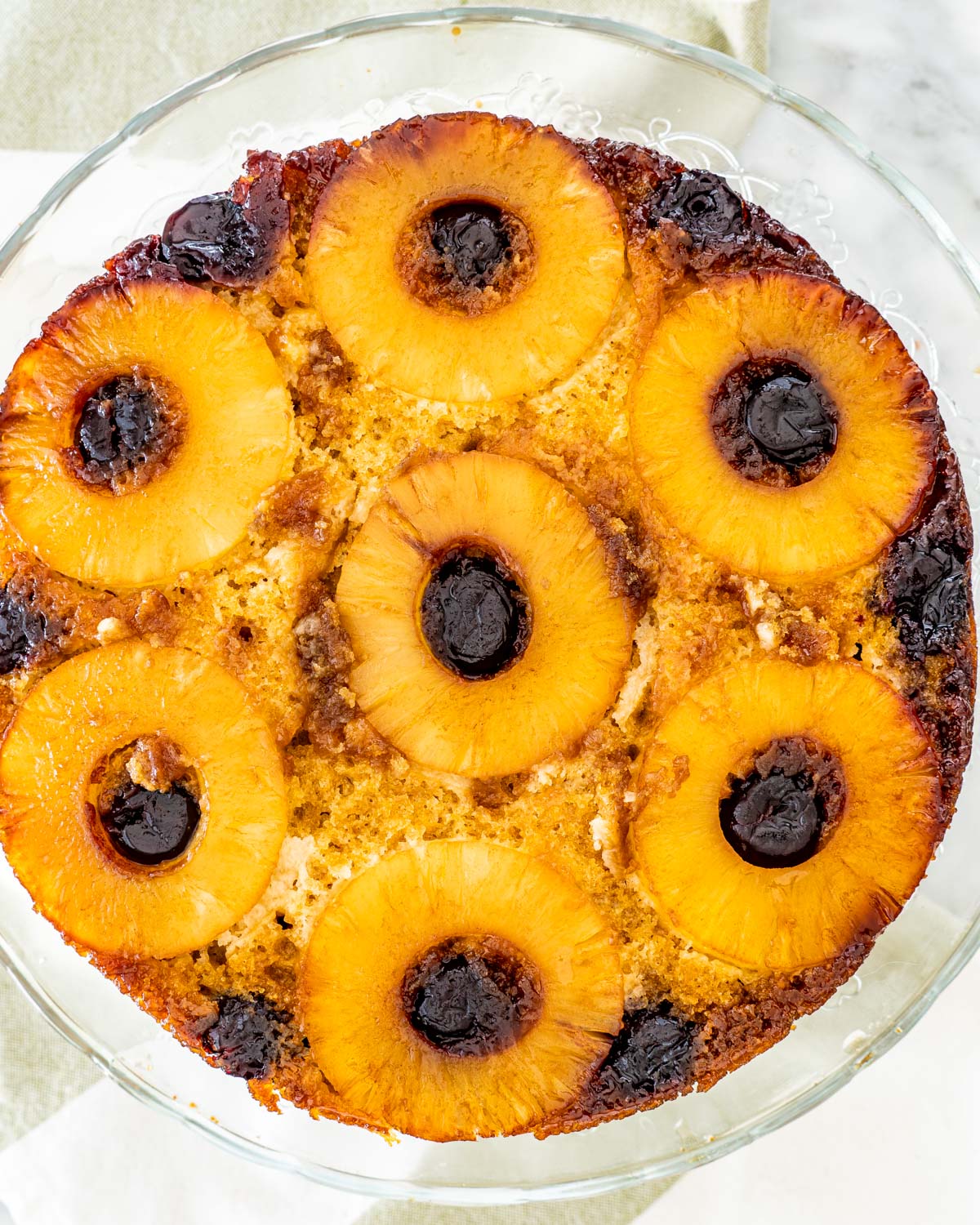 overhead shot of a gorgeous pineapple upside down cake on a cake platter