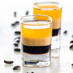 side view shot of b52 shot glasses with coffee beans around