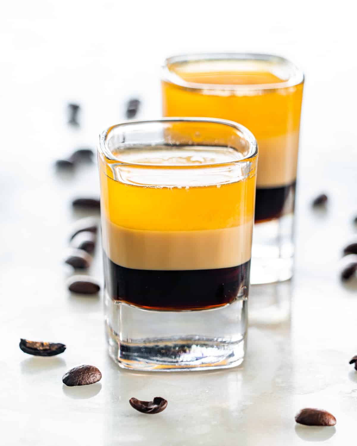 side view shot of b52 shot glasses with coffee beans around