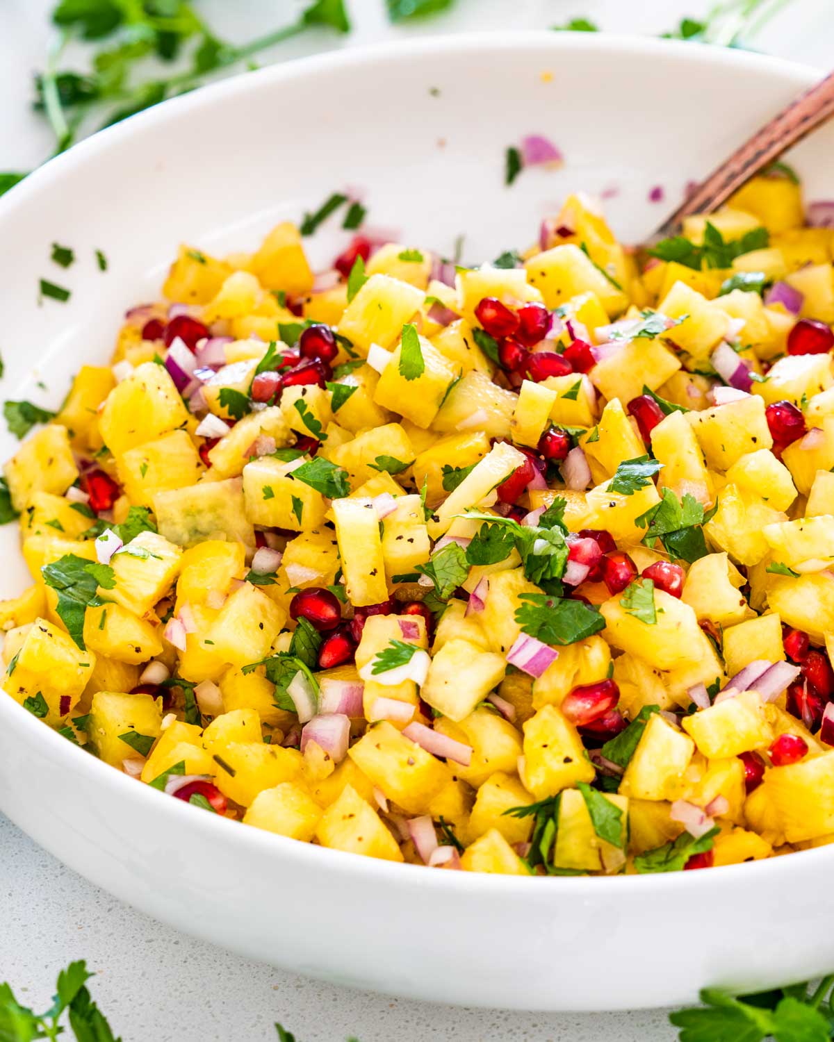 freshly made pineapple salsa in a white bowl.
