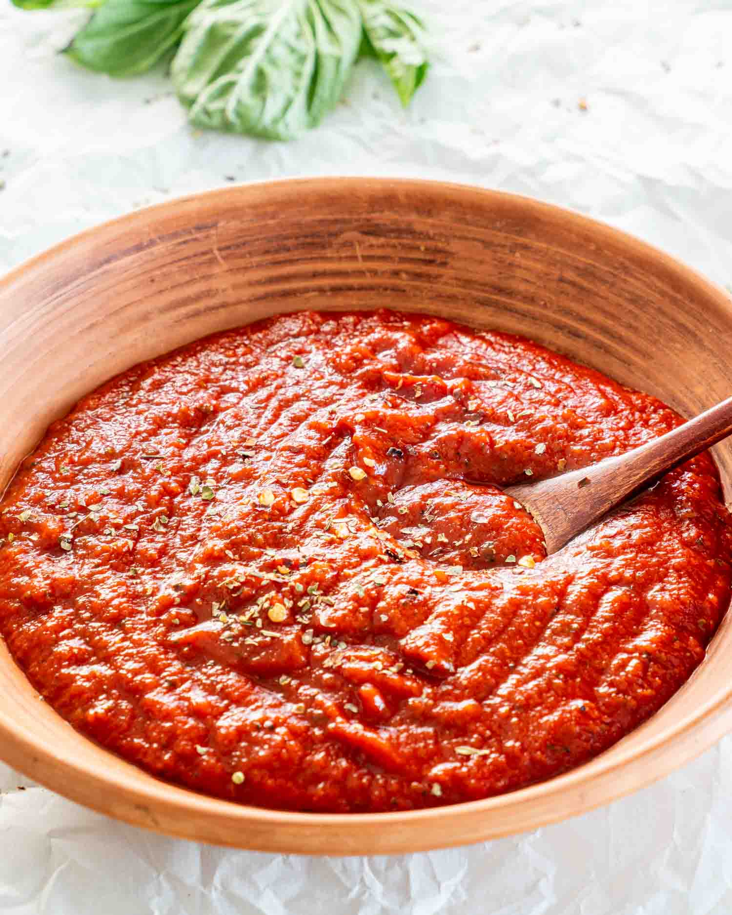 freshly made pizza sauce in a brown clay bowl.
