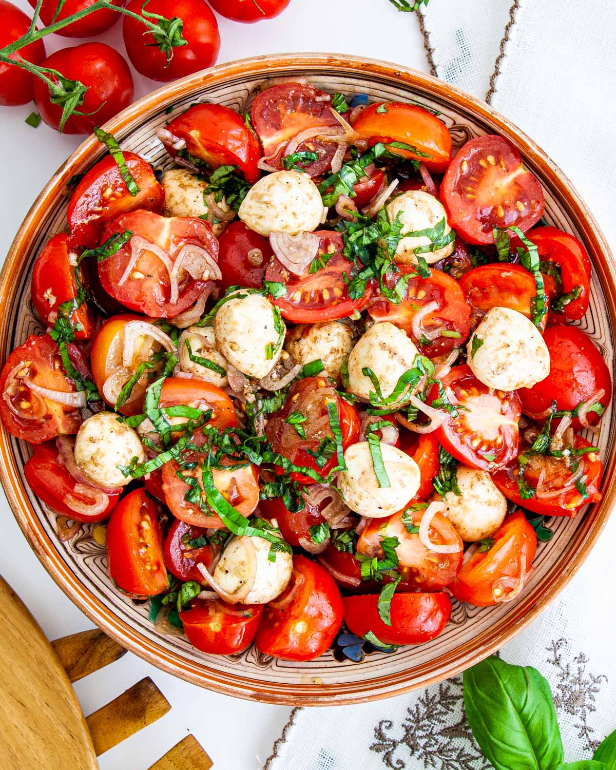 overhead shot of tomato basil salad with bocconcini in a bowl 