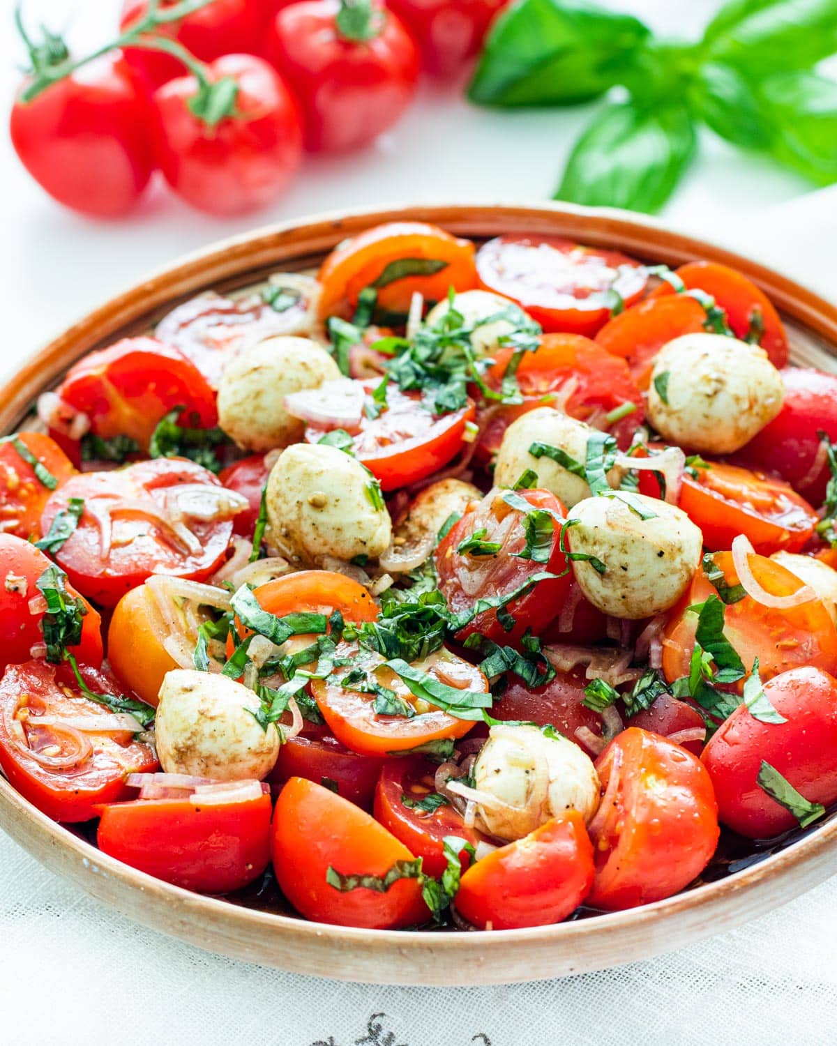 tomato basil salad in a small serving bowl