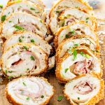 side view shot of 2 pieces of chicken cordon blue sliced on a cutting board