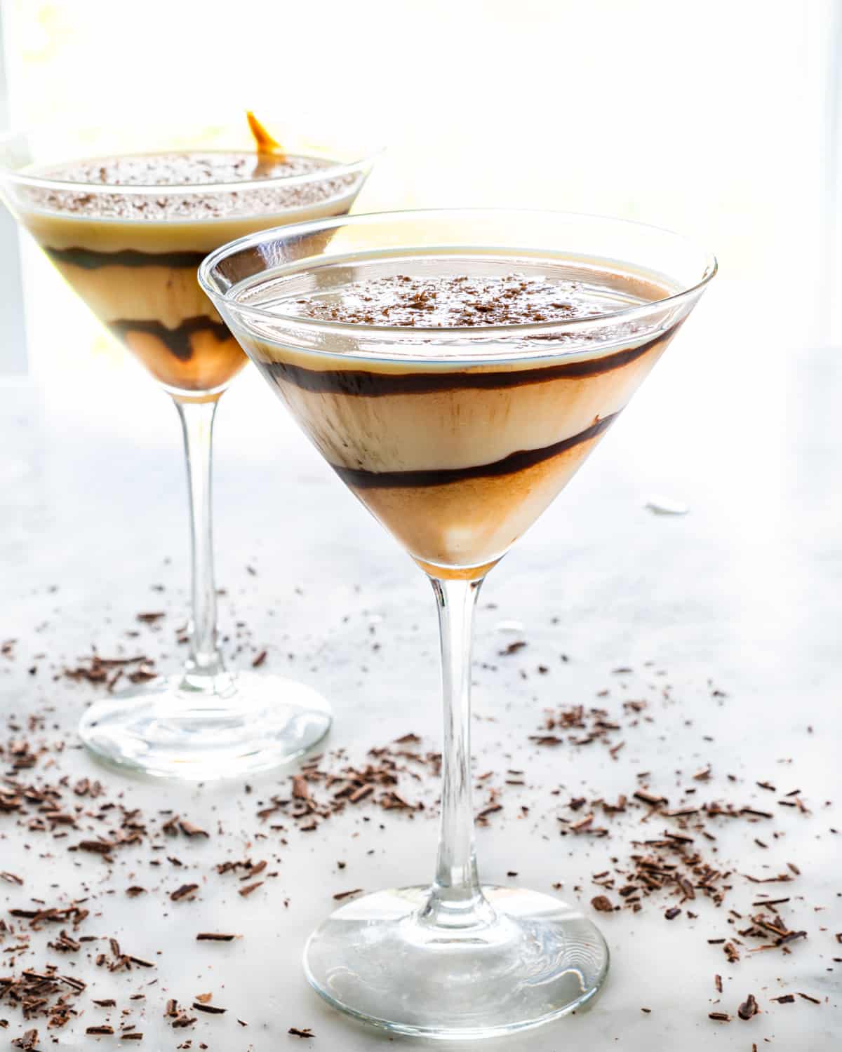 side view shot of 2 martini glasses filled with chocolate martini cocktail