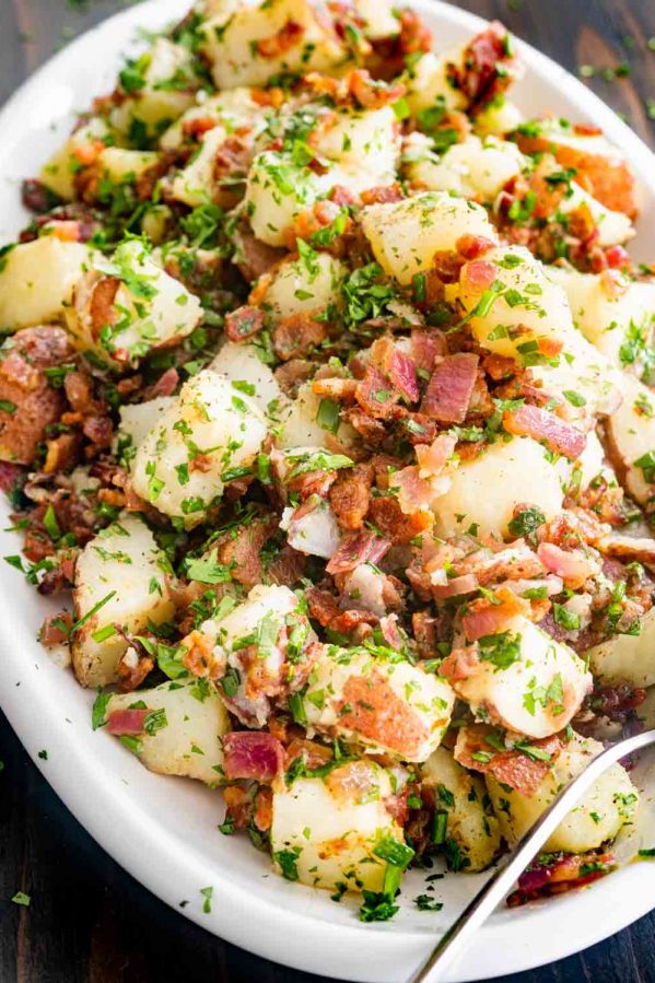 german potato salad in a white platter.