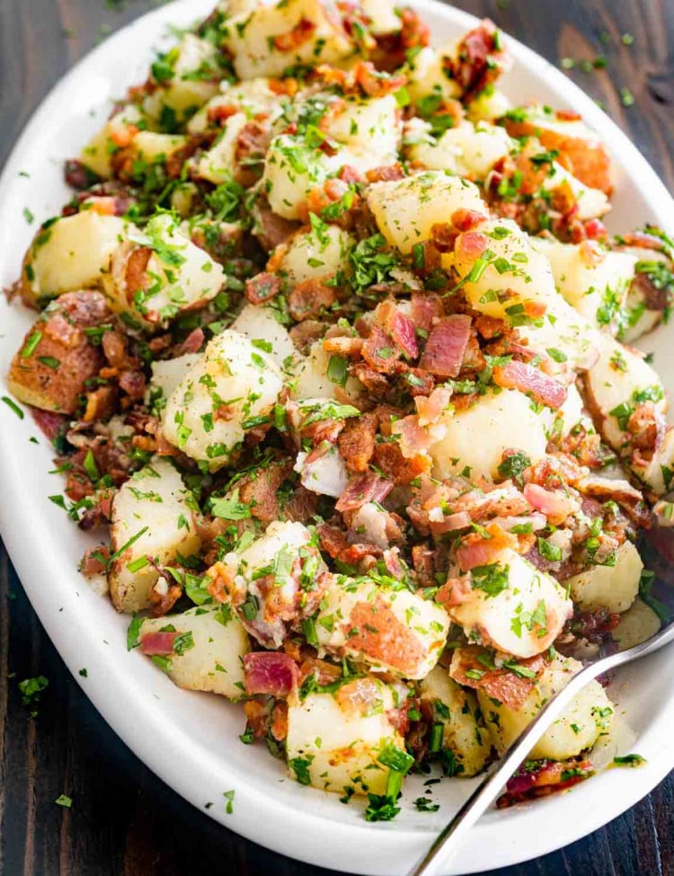 german potato salad in a white platter.