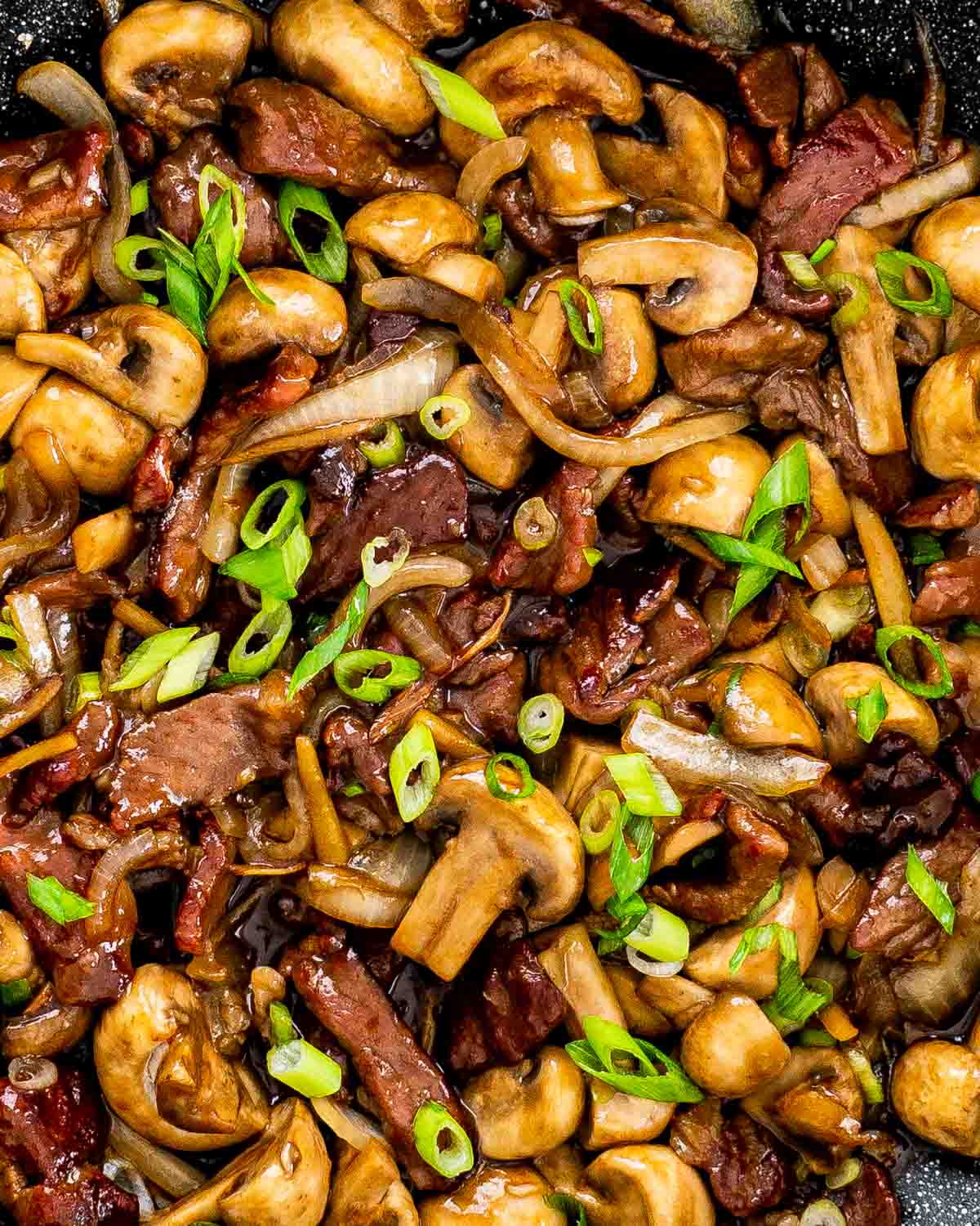 beef mushroom stir fry in a wok