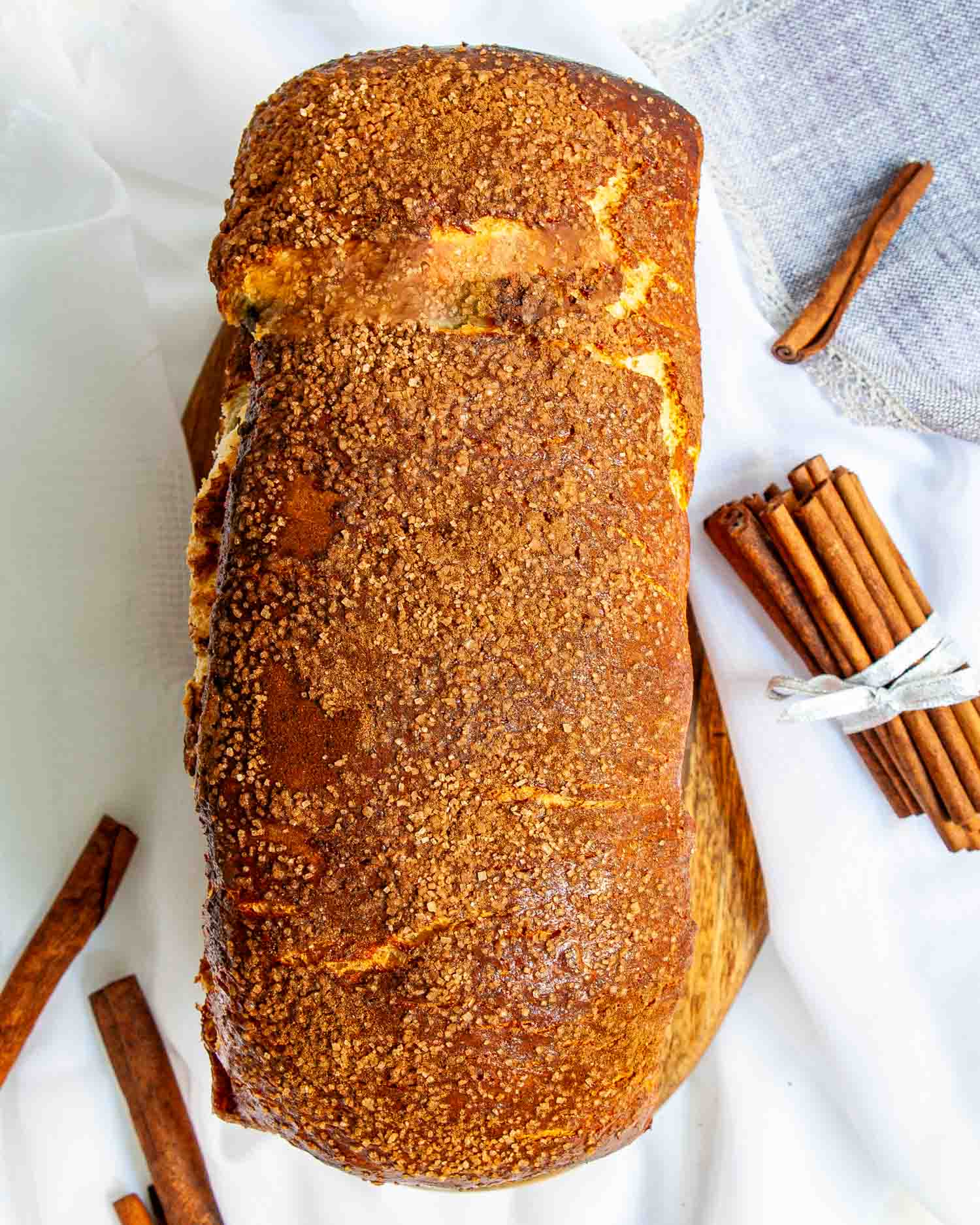 a freshly baked cinnamon bread along some cinnamon sticks.