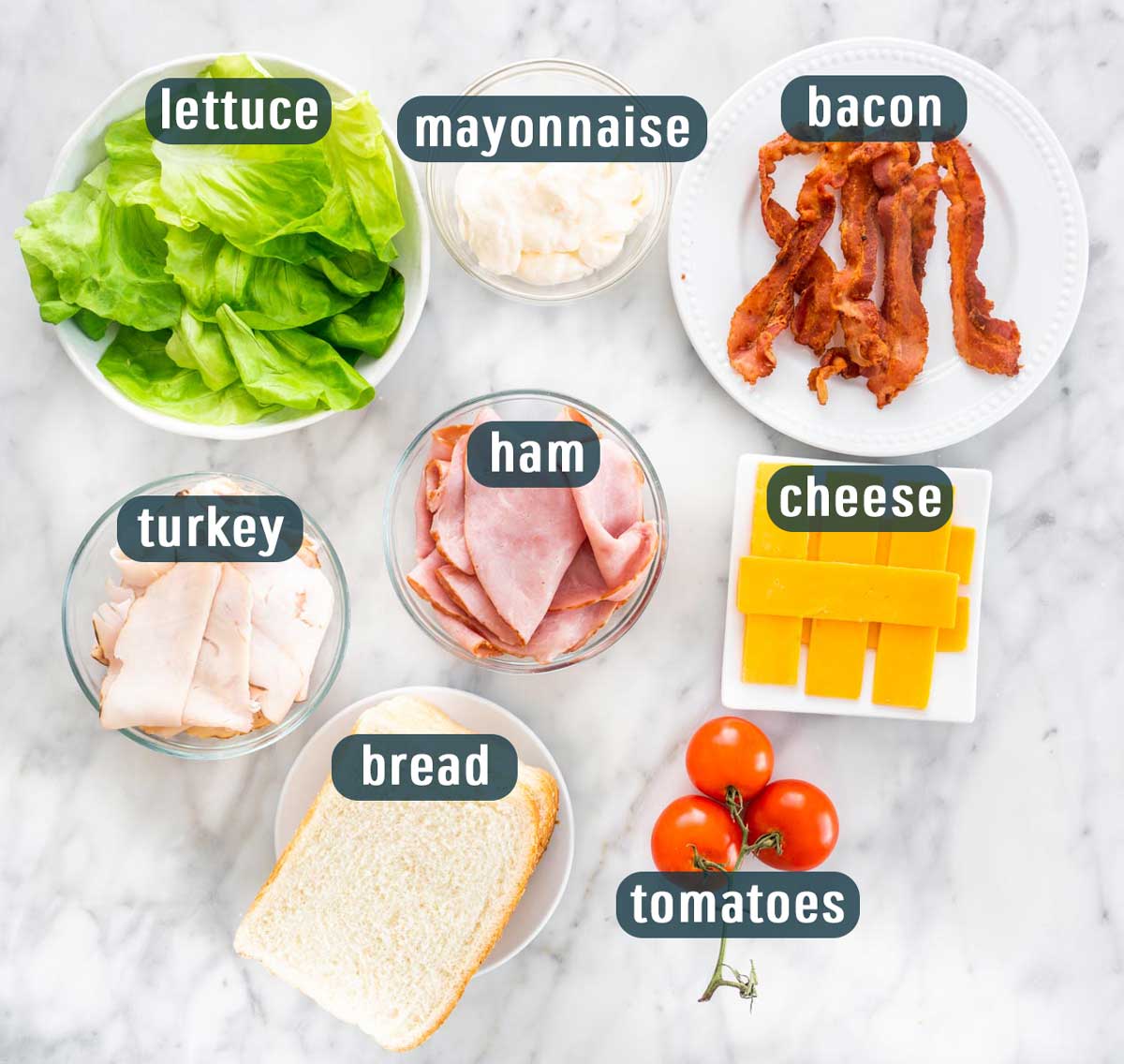 overhead of all the ingredients needed to make a club sandwich.