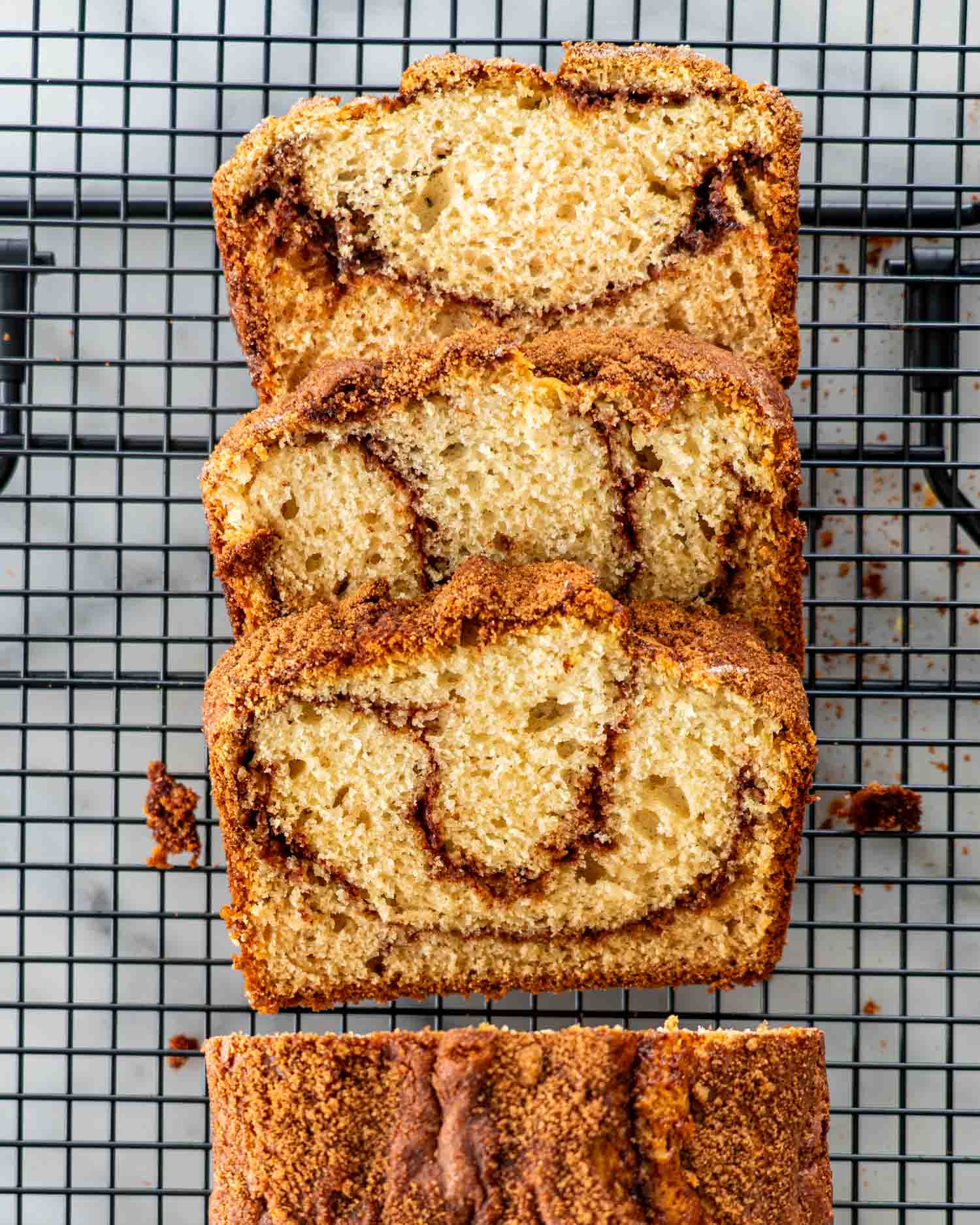slices of freshly baked coffee cake bread on a cooling rack.