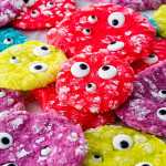 freshly baked monster cookies of all different neon colors with eyeball candy.