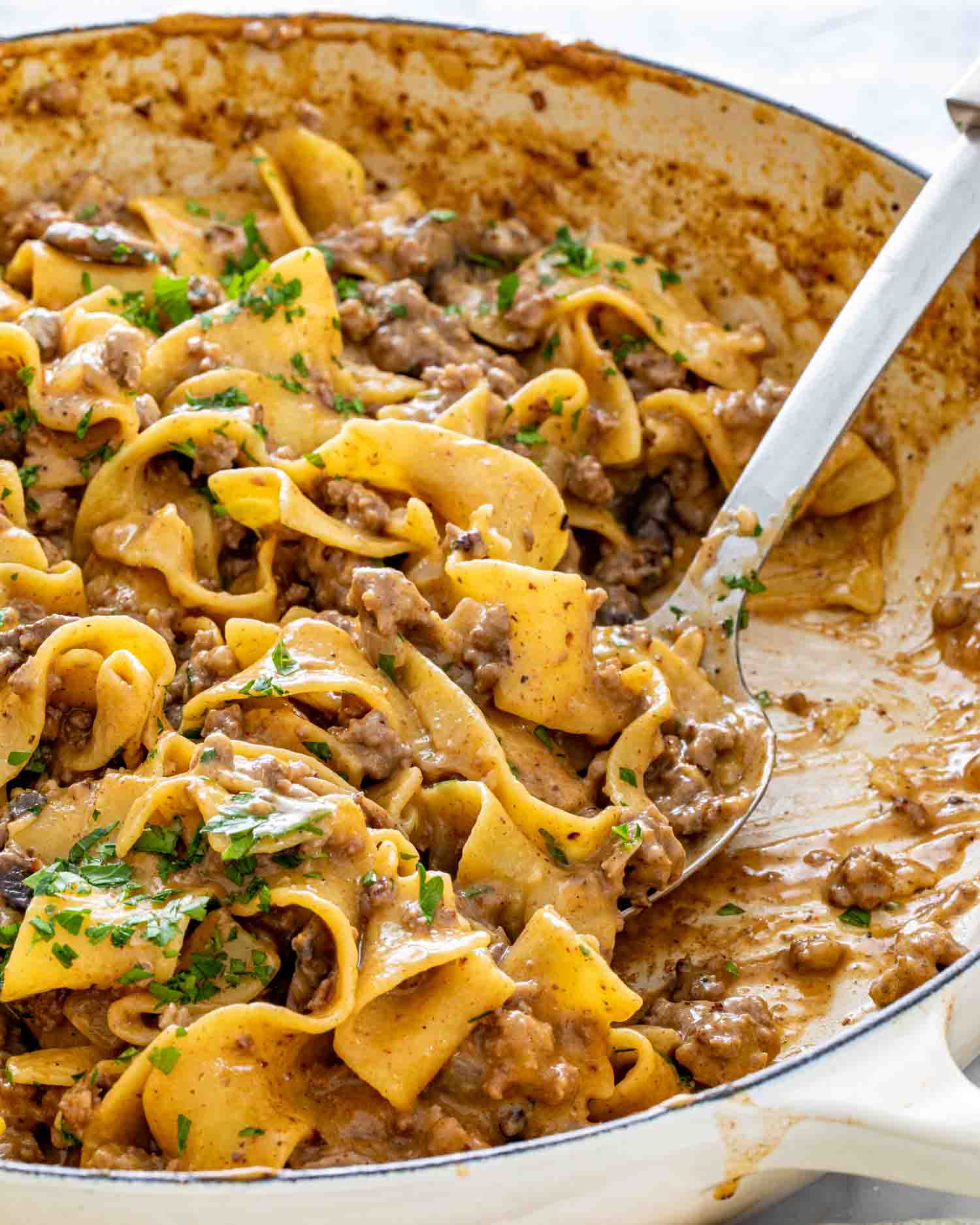 beef stroganoff with noodles in a dutch oven.