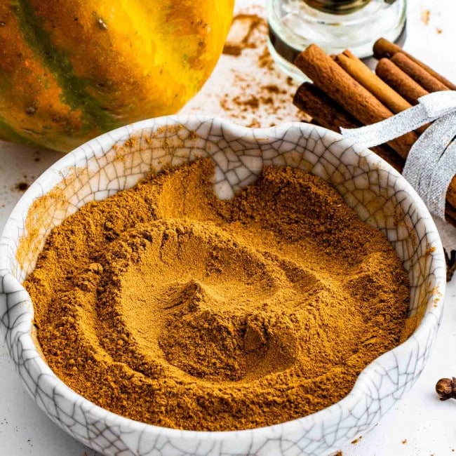 a white bowl with freshly made pumpkin pie spice.