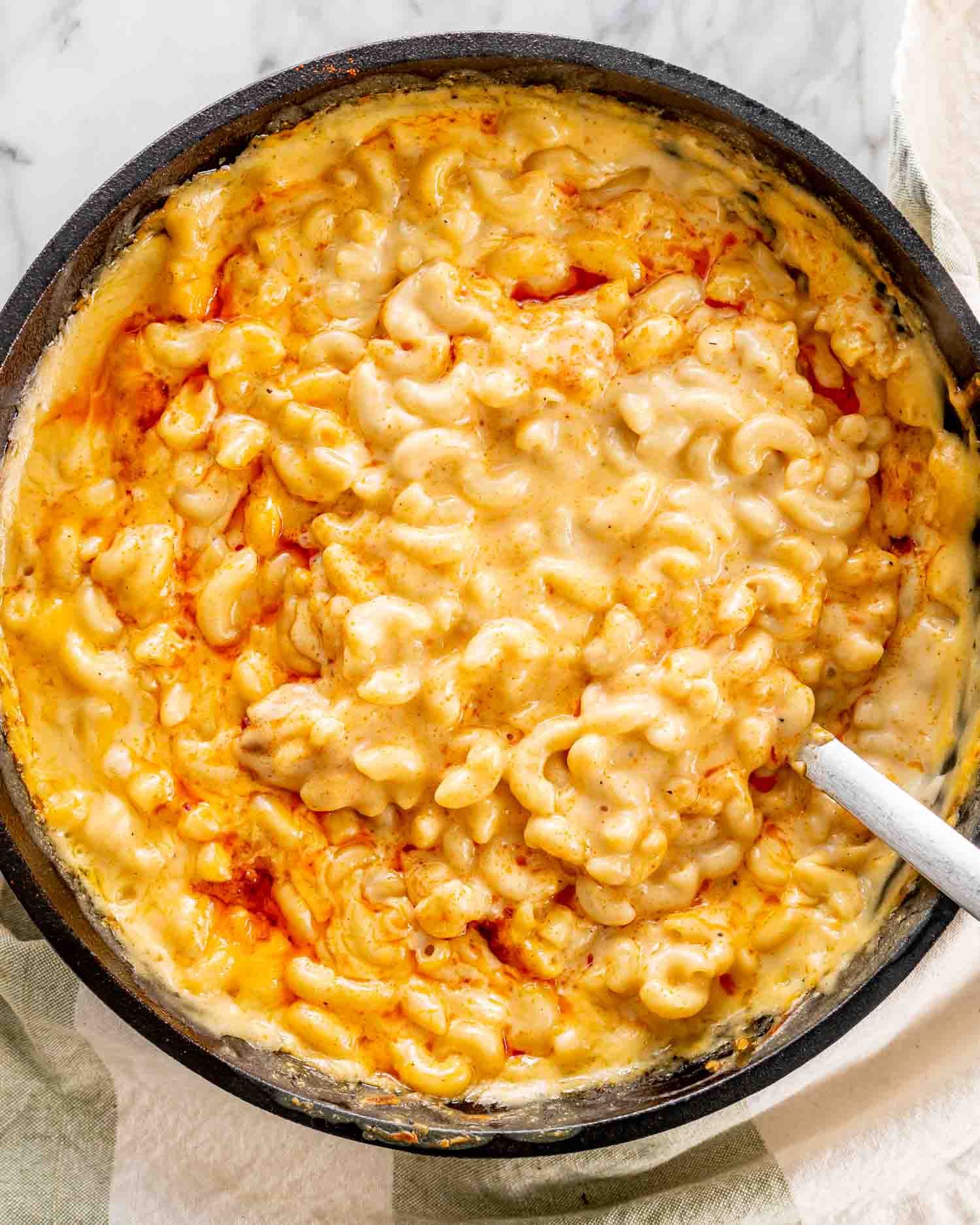 baked mac and cheese in a black cast iron skillet.
