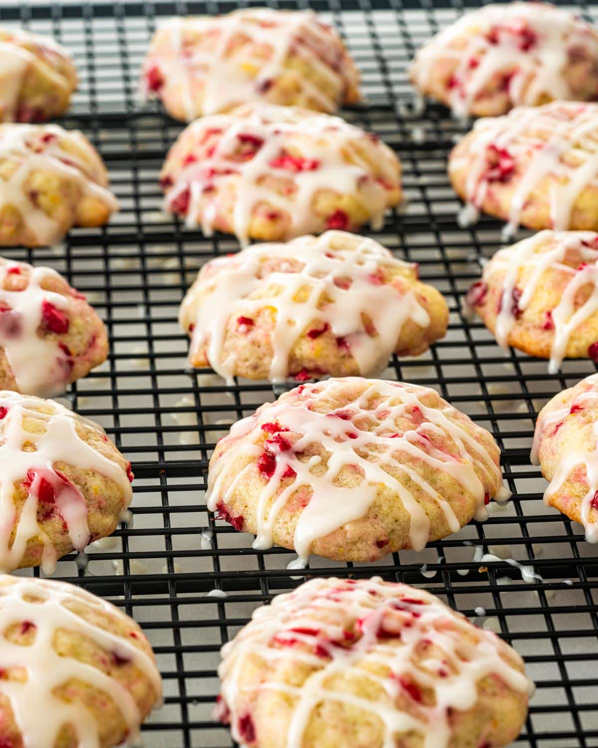 iced cranberry orange cookies on a cooling rack.