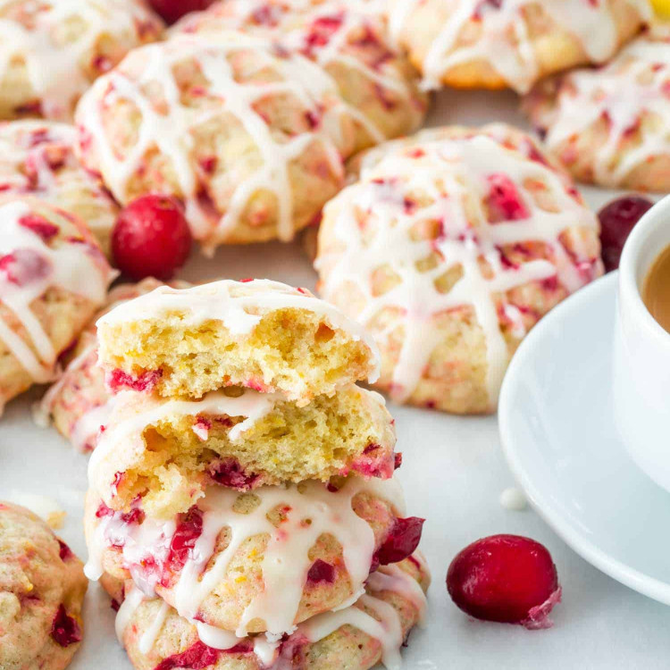 a bunch of cranberry orange cookies with a cup of coffee.
