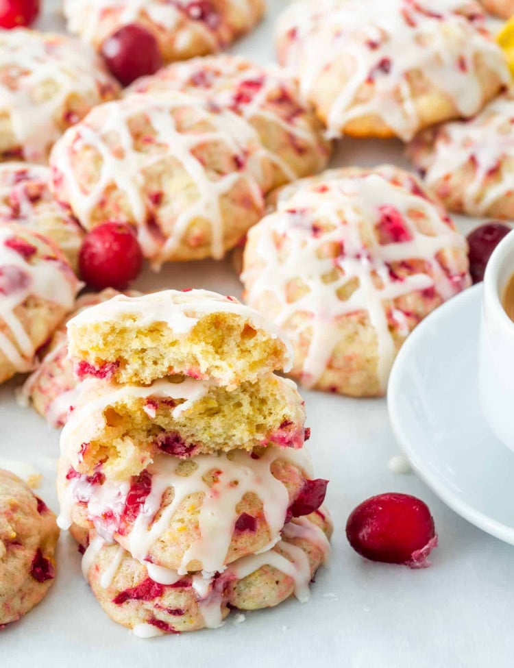 a bunch of cranberry orange cookies with a cup of coffee.