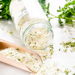 a jar with homemade ranch dressing mix and a scoop.