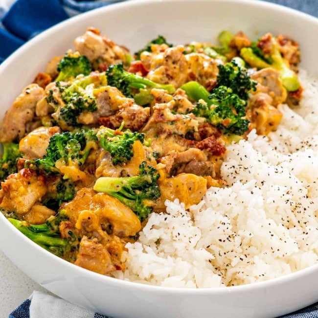 chicken broccoli with rice in a white bowl.