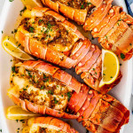 lobster tails on a white serving platter.