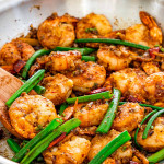 freshly made szechuan chili shrimp in a skillet.