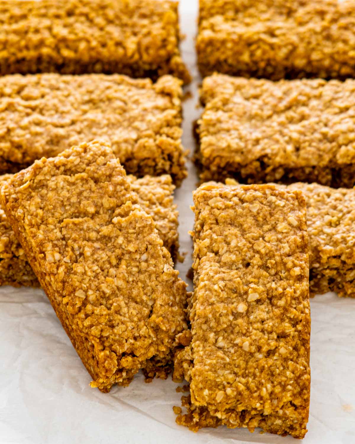 cut up bars of oatcakes on parchment paper.