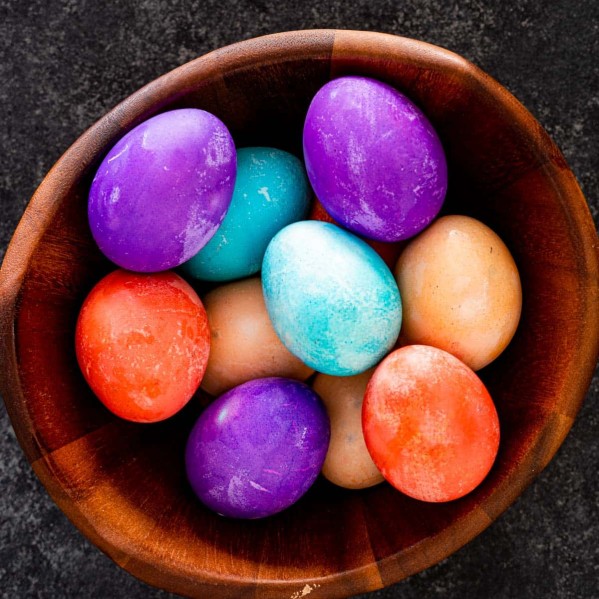 overhead shot of easter eggs in a wooden basket.