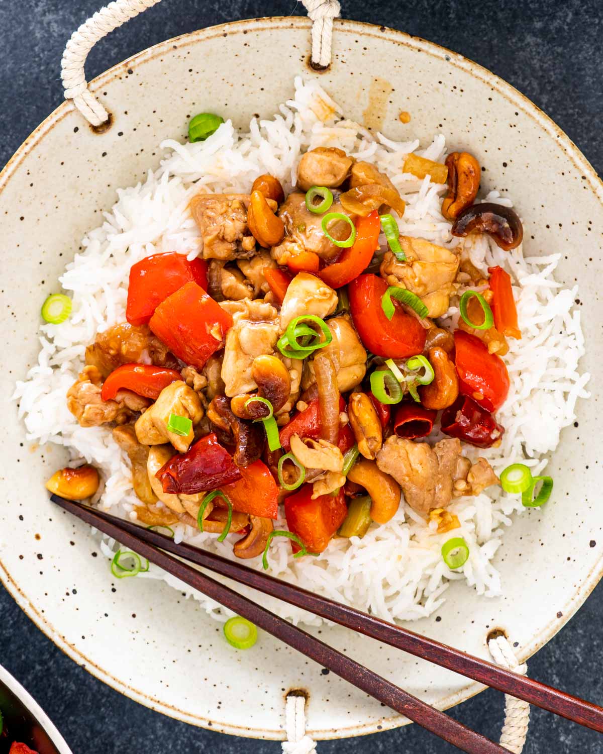 thai cashew chicken over a bed of rice.