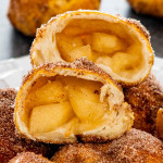 apple pie bombs on a white plate with the top one cut in half.