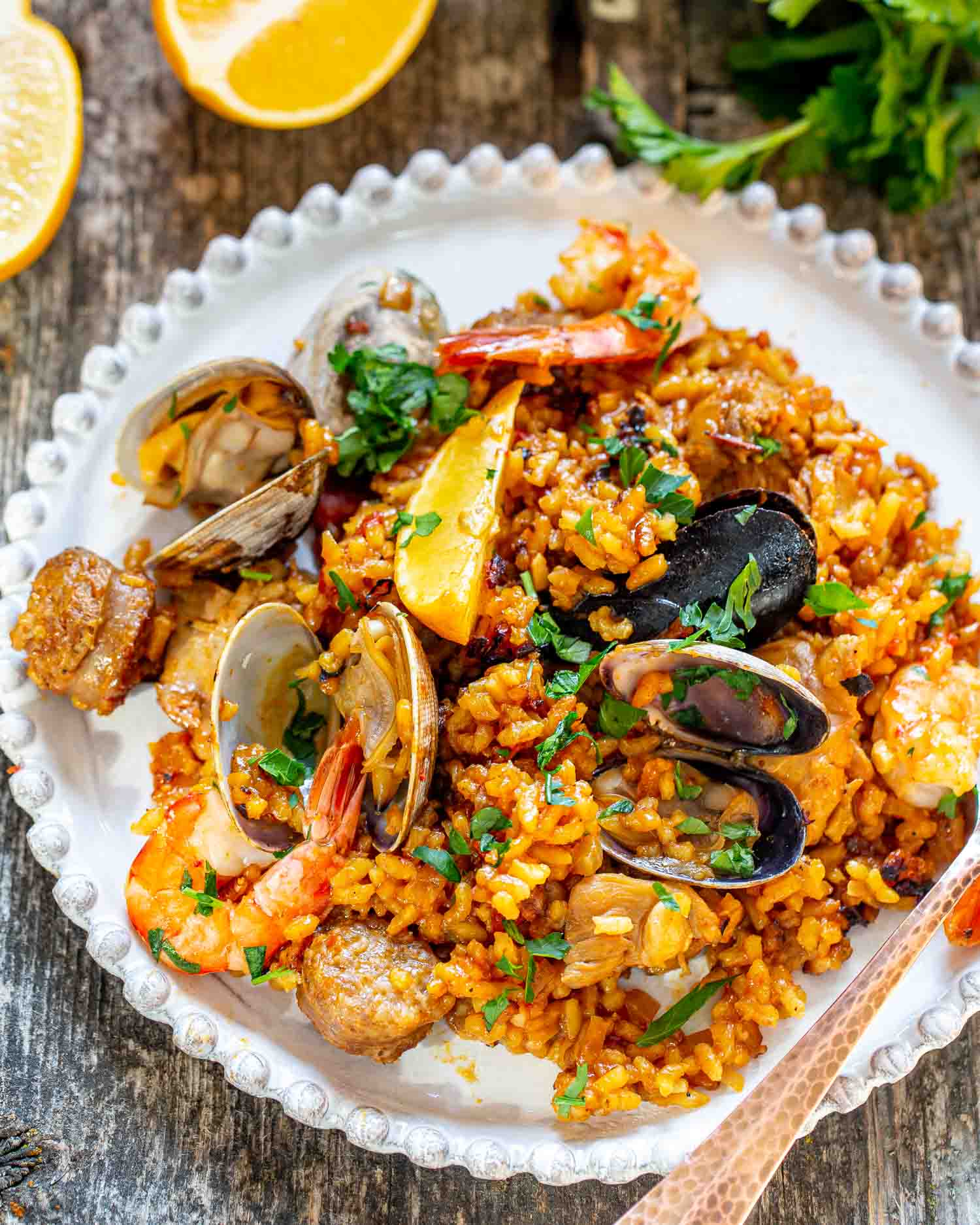 a serving of paella in a white plate.