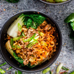 dan dan noodles in a black bowl.